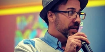 Paul O'Brien speaking into a microphone