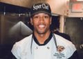Black man in a baseball cap that says Super Chef
