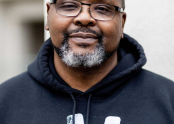 A black man with glasses and a sliightly graying beard