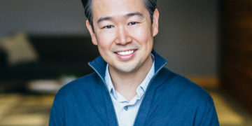 Asian American man looking at the camera