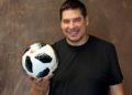 man in black shirt holding a soccer ball