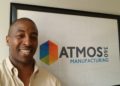 Black Man with company logo in the background, Atmos