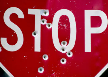 Stop sign with bullet holes