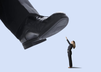 foot stepping on businesswoman