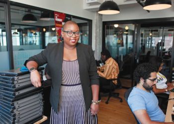Black woman standing in a computer lab