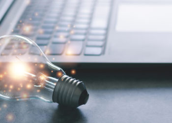 lightbulb by a computer